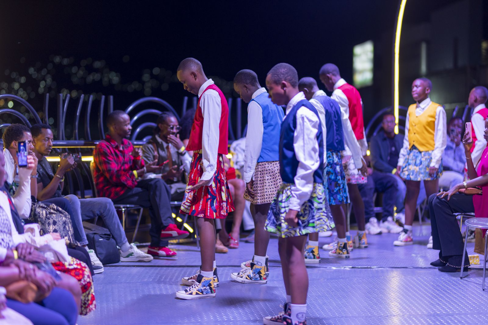 The CCF crew performing on stage at a night event in Kigali, audience watching.