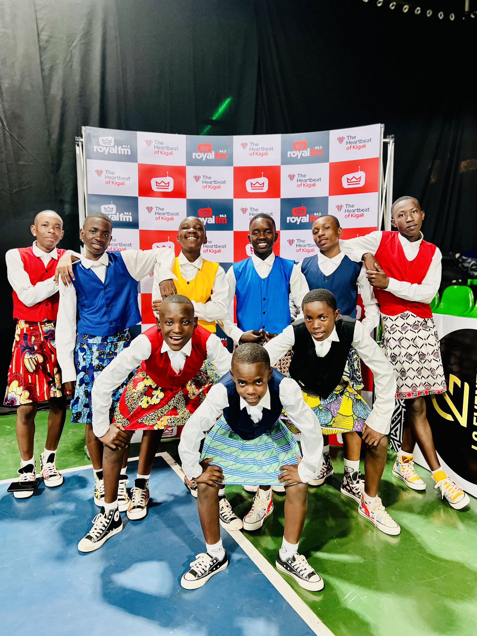 The crew at the Royal FM media wall in performance dress.